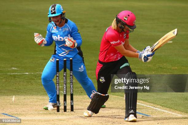 Wicketkeeper Tegan McPharlin of the Strikers celebrates the wicket of Ellyse Perry of the Sixers during the Women's Big Bash League match between the...