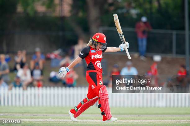 Sophie Molineux of the Renegades raises her bat after scoring 50 runs during the Women's Big Bash League match between the Melbourne Renegades and...