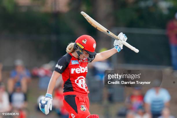 Sophie Molineux of the Renegades raises her bat after scoring 50 runs during the Women's Big Bash League match between the Melbourne Renegades and...