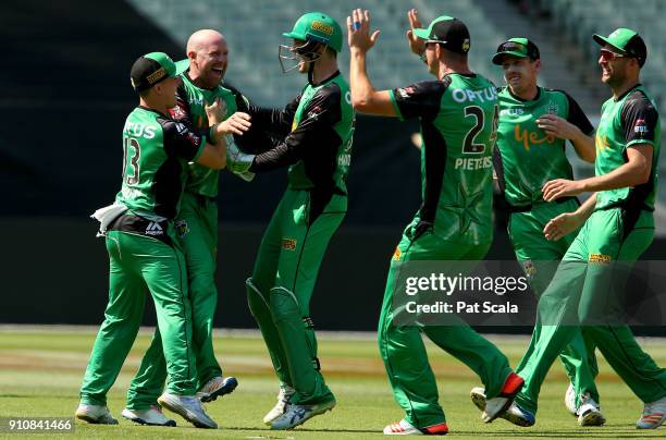 Stars Ben Dunk celebrates with teammates after dismissing Hurricanes D'Arcy Short during the Big Bash League match between the Melbourne Stars and...