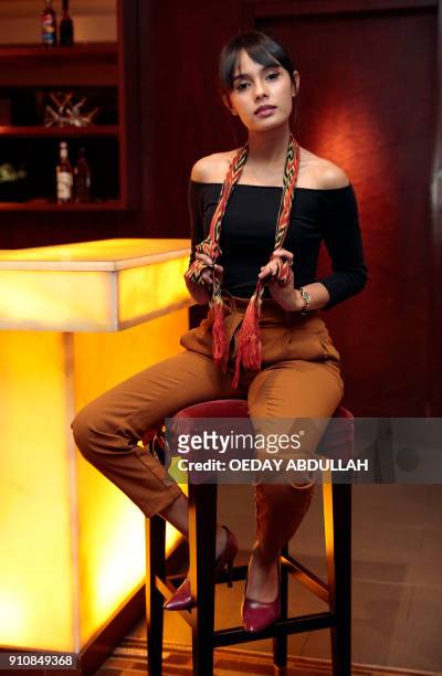 This picture taken on January 26, 2018 shows Indonesian news anchor Angie Ang posing during a promotional event in Jakarta. / AFP PHOTO / OEDAY...