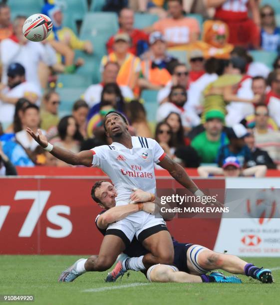 Carlin Isles of the US is tackled by Scott Riddell of Scotland during the Sydney World Rugby Sevens Series tournament in Sydney on January 27, 2018....