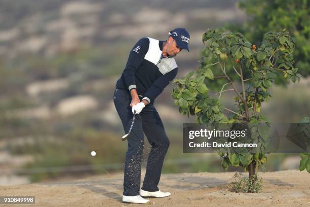 Henrik Stenson of Sweden plays left handed for his third shot on the par 5, 13th hole during the completion of the second round of the Omega Dubai...