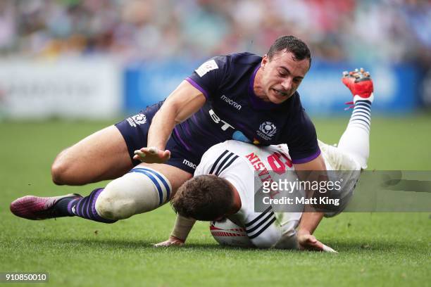 Stephen Tomasin of USA is tackled by Scott Riddell of Scotland during day two of the 2018 Sydney Sevens at Allianz Stadium on January 27, 2018 in...