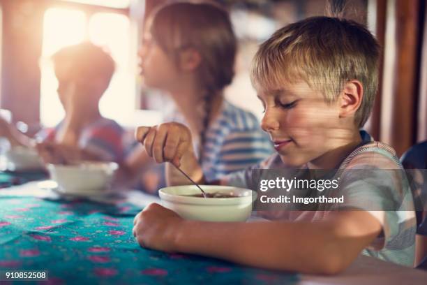 children eating soup on sunny day - eating soup stock pictures, royalty-free photos & images