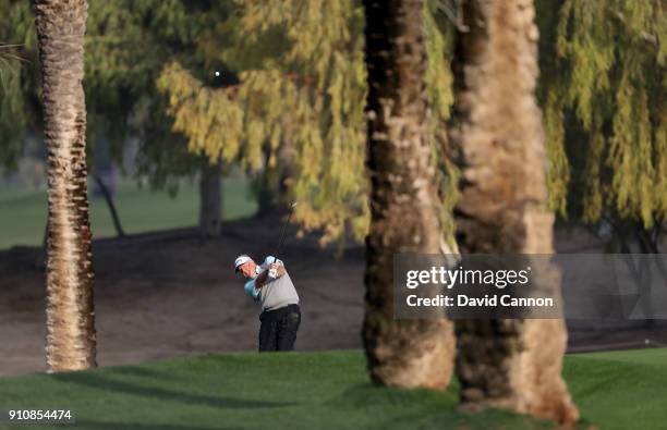 Colin Montgomerie of Scotland plays his second shot on the par 4, 17th hole during the completion of the second round of the Omega Dubai Desert...