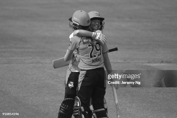 Alyssa Healy of the Sixers celebrates her century with Erin Burns during the Women's Big Bash League match between the Adelaide Strikers and the...