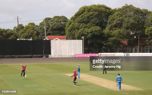 Alyssa Healy of the Sixers celebrates her century during the Women's Big Bash League match between the Adelaide Strikers and the Sydney Sixers at...
