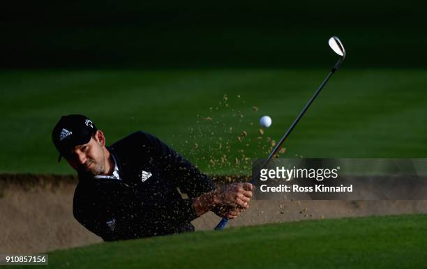Sergio Garcia of Spain plays his third shot shot on the par four 14th hole during the continuation of the delayed second round of the Omega Dubai...