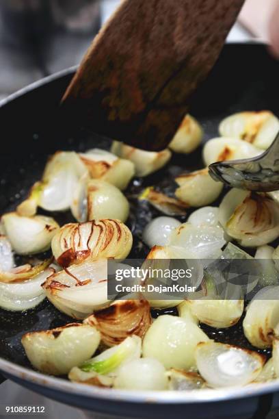 sliced onion frying in the pan - stir frying european stock pictures, royalty-free photos & images