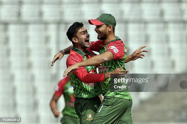 Bangladesh cricketer Mehedi Hasan Miraz celebrates along with captain Mashrafe Bin Mortaza after the dismissal of Sri Lankan batsman Danushka...