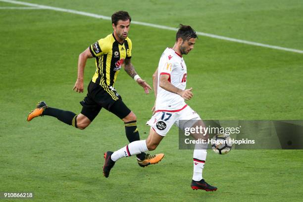 Nikola Mileusnic of Adelaide United and Tom Doyle of the Phoenix compete for the ball during the round 18 A-League match between the Wellington...
