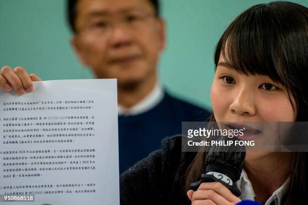Pro-democracy student Agnes Chow holds a document from the goverment as she is being banned from the election on Januray 27, 2018 Chow a former...