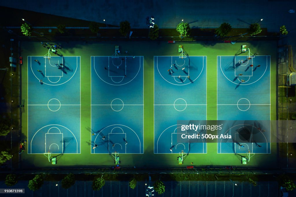 Aerial view of basketball courts with players at night, Shanghai, China