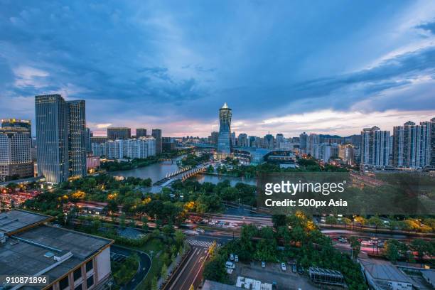cloudy sky over city at dusk, hangzhou, china - west lake hangzhou fotografías e imágenes de stock