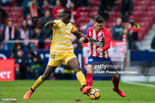 Lucas Hernandez of Atletico de Madrid fights for the ball with Michael Olunga Ogada of Girona FC during the La Liga 2017-18 match between Atletico de...