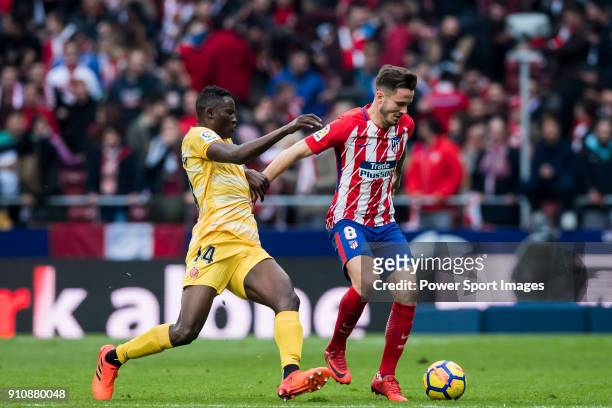 Saul Niguez Esclapez of Atletico de Madrid fights for the ball with Michael Olunga Ogada of Girona FC during the La Liga 2017-18 match between...
