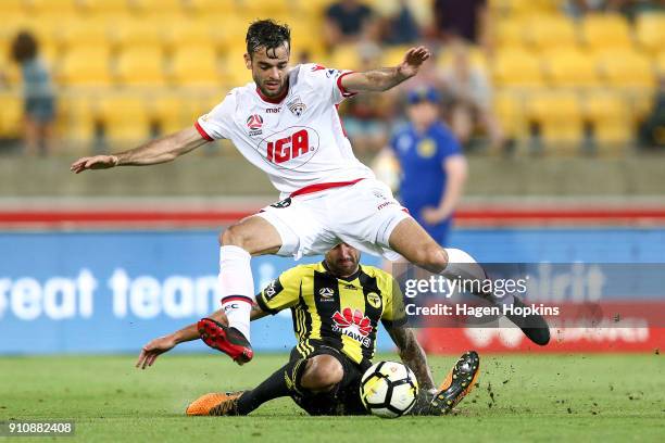 Nikola Mileusnic of Adelaide United is tackled by Tom Doyle of the Phoenix during the round 18 A-League match between the Wellington Phoenix and...