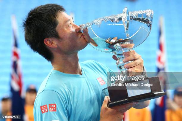 Shingo Kunieda of Japan poses with the championship trophy after winning the Men's Wheelchair Singles Final against Stephane Houdet of France during...