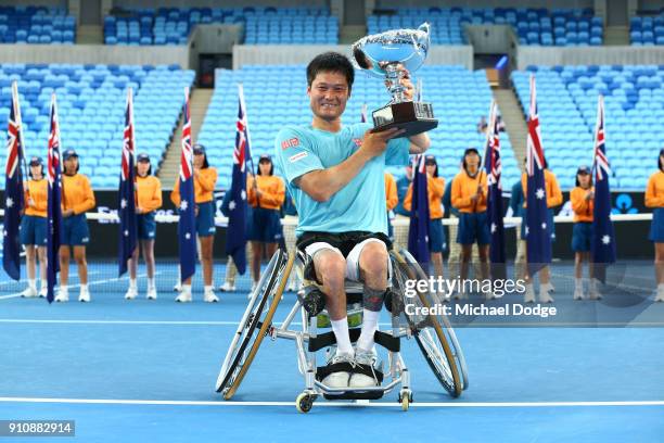 Shingo Kunieda of Japan poses with the championship trophy after winning the Men's Wheelchair Singles Final against Stephane Houdet of France during...