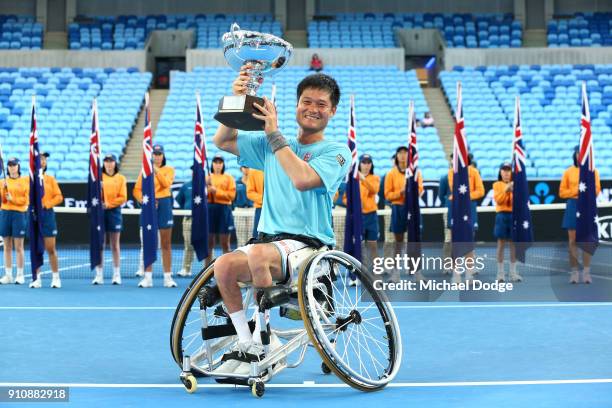 Shingo Kunieda of Japan poses with the championship trophy after winning the Men's Wheelchair Singles Final against Stephane Houdet of France during...