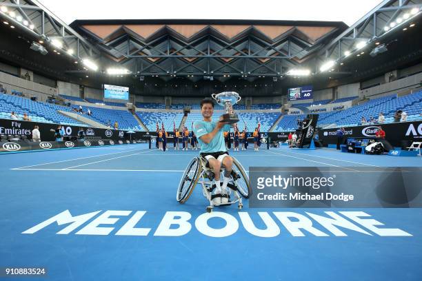 Shingo Kunieda of Japan poses with the championship trophy after winning the Men's Wheelchair Singles Final against Stephane Houdet of France during...