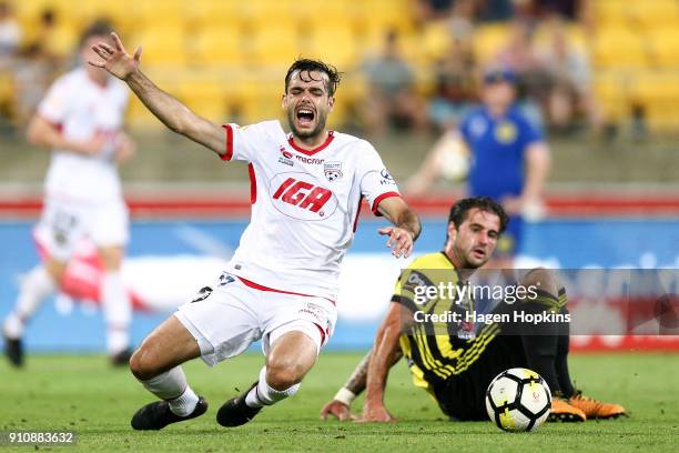 Nikola Mileusnic of Adelaide United is tackled by Tom Doyle of the Phoenix during the round 18 A-League match between the Wellington Phoenix and...