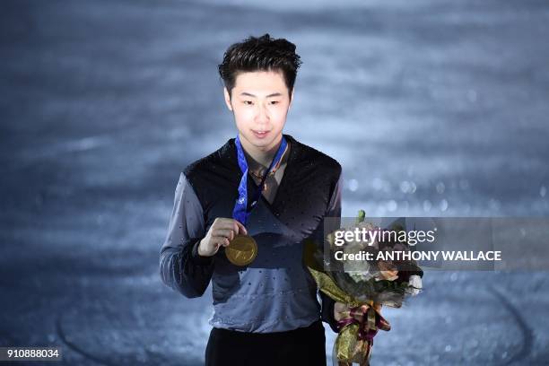 Gold medallist Boyang Jin of China poses on the rink during the victory ceremony for the men's free skating program at the ISU Four Continents figure...