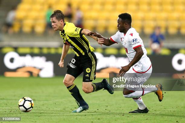 Michael McGlinchey of the Phoenix makes a break from Mark Ochieng of Adelaide United during the round 18 A-League match between the Wellington...