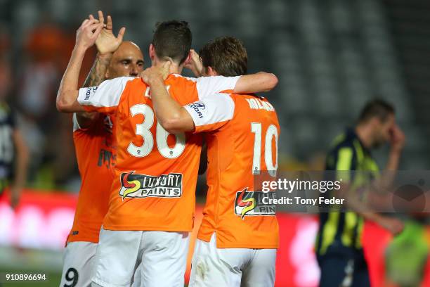 Brett Holman of the Roar celebrates a goal with team mates Daniel Leck and Massimo Maccarone during the round 18 A-League match between the Central...