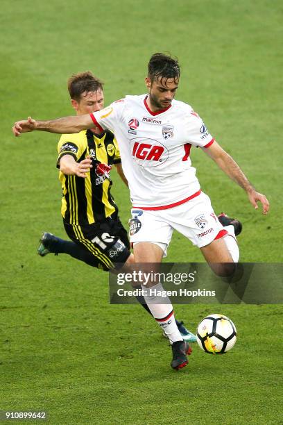 Nikola Mileusnic of Adelaide United beats the challenge of Michael McGlinchey of the Phoenix during the round 18 A-League match between the...