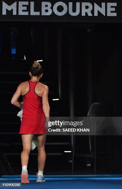 Romania's Simona Halep walks off the court as the heat rule is in effect against Denmark's Caroline Wozniacki during their women's singles final...