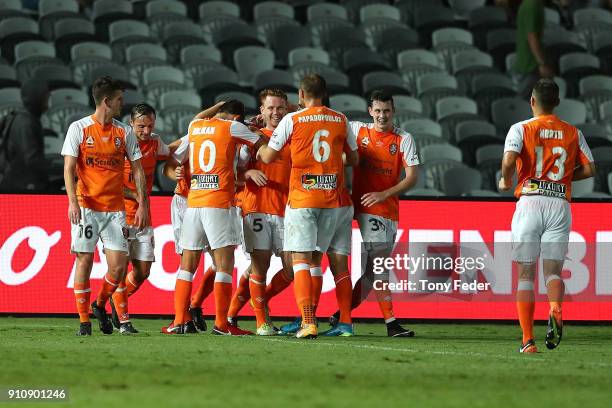 Brisbane Roar players celebrate a goal during the round 18 A-League match between the Central Coast Mariners and the Brisbane Roar at Central Coast...