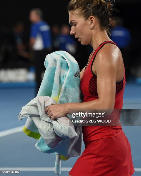 Romania's Simona Halep walks off the court as the heat rule comes into effect against Denmark's Caroline Wozniacki during their women's singles final...