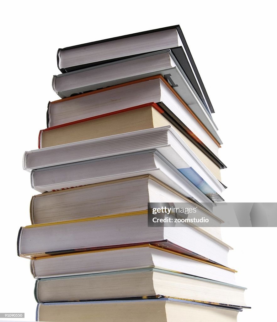 Stack of different kinds of books isolated on white