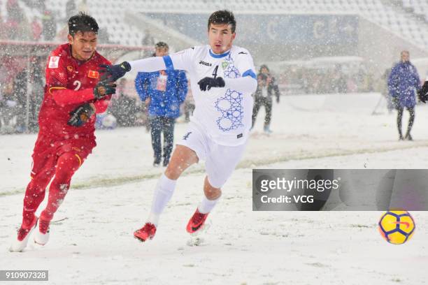 Pham Xuan Manh of Vietnam and Akramjon Komilov of Uzbekistan compete for the ball during the AFC U23 Championship China 2018 final match between...