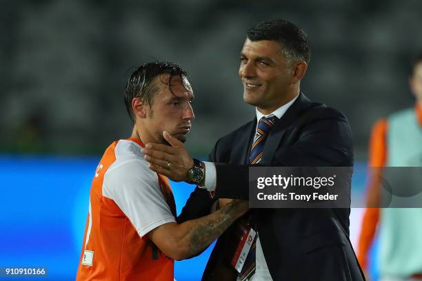 John Aloisi of the Roar congratulates Eric Bautheac of the Roar after the finish of the game during the round 18 A-League match between the Central...