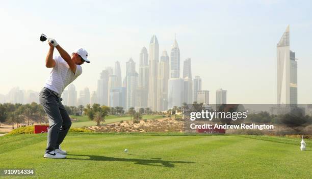 Trevor Immelman of South Africa tees off on the 8th hole with the city as a backdrop during day three of Omega Dubai Desert Classic at Emirates Golf...