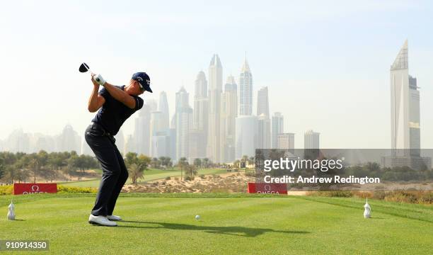 Henrik Stenson of Sweden tees off on the 8th hole with the city as a backdrop during day three of Omega Dubai Desert Classic at Emirates Golf Club on...