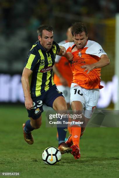 Wout Brama of the Mariners contests the ball with Brett Holman of the Roar during the round 18 A-League match between the Central Coast Mariners and...