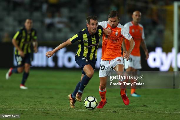 Wout Brama of the Mariners contests the ball with Brett Holman of the Roar during the round 18 A-League match between the Central Coast Mariners and...