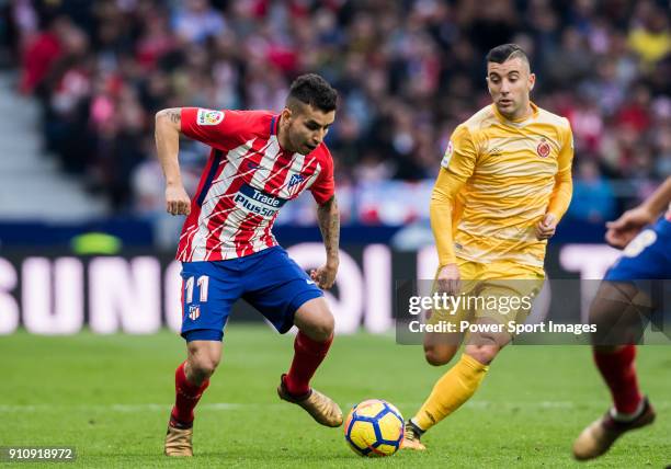 Angel Correa of Atletico de Madrid fights for the ball with Borja Garcia Freire of Girona FC during the La Liga 2017-18 match between Atletico de...