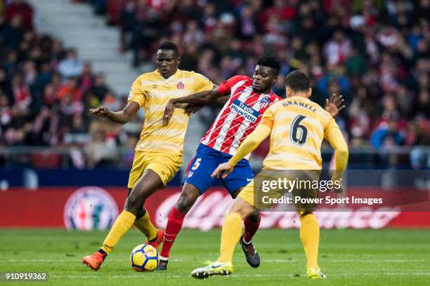 Thomas Teye Partey of Atletico de Madrid fights for the ball with Michael Olunga Ogada and Alex Granell Nogue of Girona FC during the La Liga 2017-18...