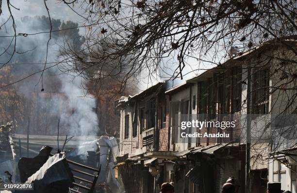 Afghan security officials inspect the blast side in Kabul, Afghanistan on January 27, 2018. At least 40 people were killed and 140 others injured...