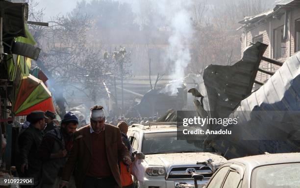 Afghan security officials inspect the blast side in Kabul, Afghanistan on January 27, 2018. At least 40 people were killed and 140 others injured...
