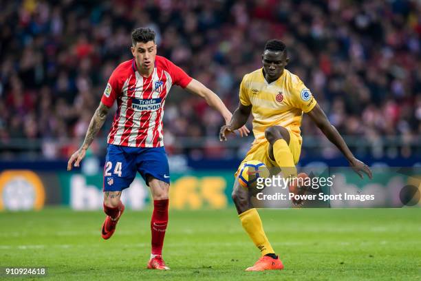 Michael Olunga of Girona FC competes for the ball with Jose Maria Gimenez of Atletico de Madrid during the La Liga 2017-18 match between Atletico de...