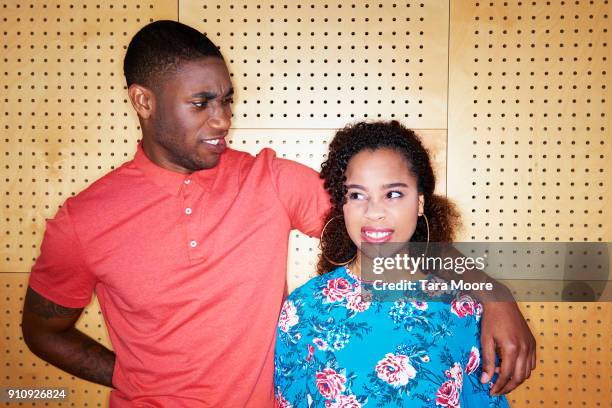 young man and woman making faces at each other - woman look straight black shirt stock pictures, royalty-free photos & images