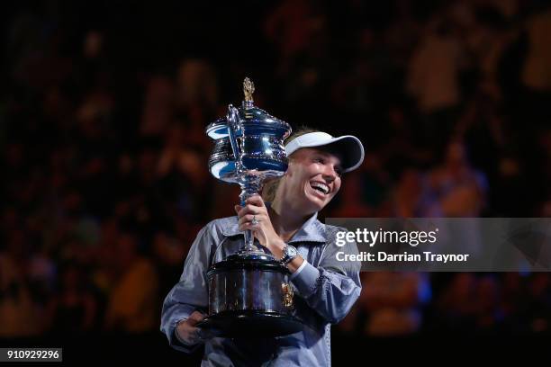 Caroline Wozniacki of Denmark poses for a photo with the Daphne Akhurst Memorial Cup after winning the women's singles final against Simona Halep of...