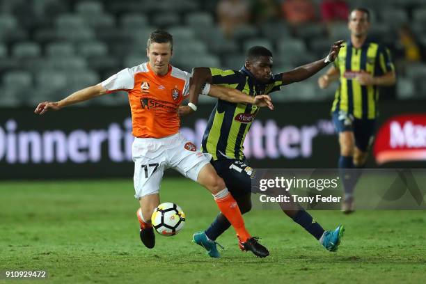 Matthew McKay of the Roar contests the ball with Kwabena Appiah of the Mariners during the round 18 A-League match between the Central Coast Mariners...