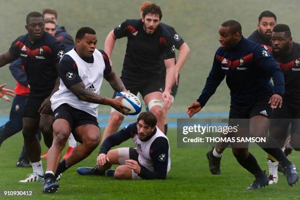 France's winger Virimi Vakatawa runs with the ball during a training session on January 27, 2018 at France's training camp in Marcoussis, south of...